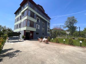 a large building with benches in front of it at Shen Home Life in Trabzon