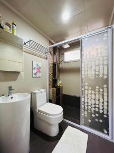 y baño con aseo y ducha acristalada. en The Haven Suite en Bentong