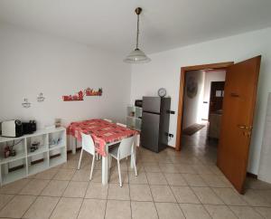 uma cozinha com uma mesa com cadeiras e um frigorífico em Dolce Ricordo, locazione turistica em Marano Vicentino