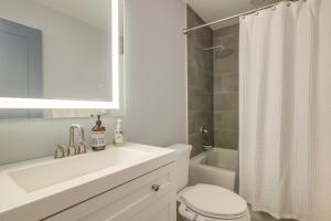 a white bathroom with a sink and a toilet at Lago Vista Vacation Rental with Fireplace! in Lago Vista +25 photos