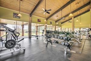 a gym with a lot of treadmills and weights at Lago Vista Vacation Rental with Fireplace! in Lago Vista
