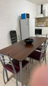 a wooden table with a bowl on it in a kitchen at Alquiler por día. in Firmat