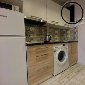 a kitchen with a washer and a washing machine at Studio Aparment in Kharkiv