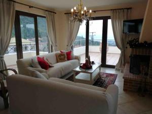 a living room with a couch and a table at Gerania Villa in Písia