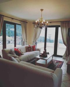 a living room with two couches and a table at Gerania Villa in Písia