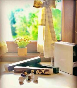 a window with books and glasses on a table at Gerania Villa in Písia +59 photos
