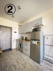 a kitchen with a refrigerator and a dishwasher at Studio Aparment in Kharkiv