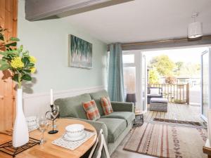 a living room with a couch and a table at Samphire in Caernarfon