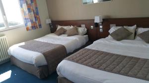Postel nebo postele na pokoji v ubytování Hotel De La Mer