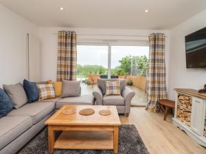 a living room with a couch and a table at Delabere Road in Bishops Cleeve