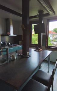 a kitchen with a large wooden table with two chairs at Quiet place in Kaunas