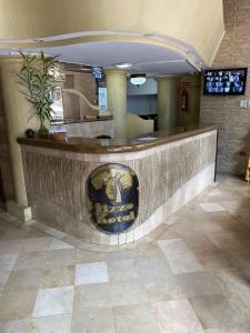 a lobby with a bar with a lion painted on it at Hotel Rizzo in Guayaquil