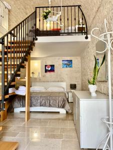 a bedroom with a bed and a staircase at Casa Melina! Historic house in Locorotondo in Locorotondo