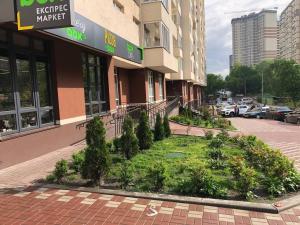 a building with a garden in front of a building at Apartment Kiev Studio with city view in Kyiv
