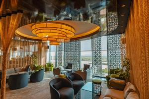 a lobby with couches and chairs and windows at Radisson Blu Hotel & Conference Center, Niamey in Niamey