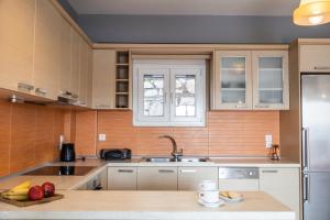 a kitchen with a sink and a counter with fruit on it at Home Sweet Home Unique Sea View in Sivota +6 photos