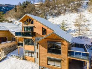an aerial view of a log home in the snow at Chalet Lumière - LaGodille Prestige - 16 personnes - Pra Loup in Uvernet