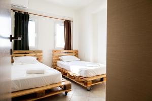 two beds on wooden pallets in a room at Home Sweet Home Unique Sea View in Sivota