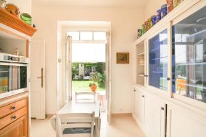 a kitchen with a table and chairs and a window at Bastide les Oréades - Villa de luxe in Marseille