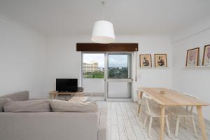 a living room with a table and a couch at Praia do Amado Flat by LovelyStay in Portimão