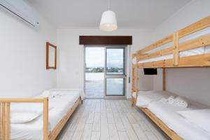 two bunk beds in a room with a window at Praia do Amado Flat by LovelyStay in Portimão