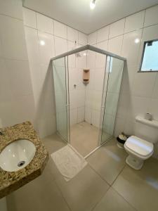 a bathroom with a shower and a sink and a toilet at Hotel Mendes Azevedo in Goiânia +51 photos