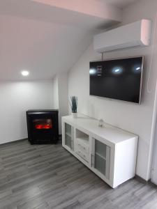 a living room with a tv and a fireplace at Paulinio in Jajce