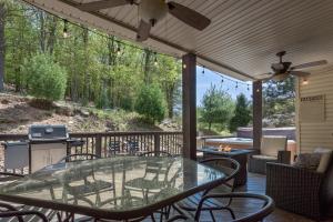 a patio with a glass table and chairs on a deck at 6 Fieldstone Ct in Lake Harmony