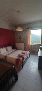 a bedroom with two beds and a large window at Windy Place in Fourfourás