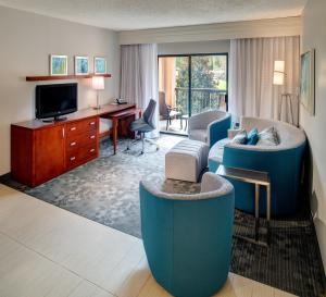 a living room with a couch and a tv at Courtyard by Marriott Columbia Northeast/Fort Jackson Area in Columbia