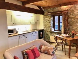 a living room with a couch and a table in a kitchen at Harvest End in York