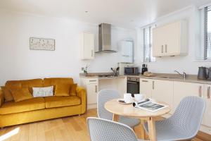 a kitchen and living room with a couch and a table at Shanklin Villa in Shanklin