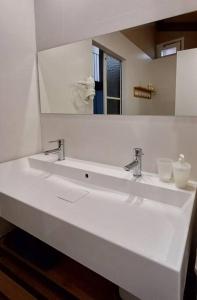a bathroom with a white sink and a mirror at FeelhomeVIC. Ático con terraza en centro histórico in Vic