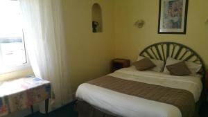 Postel nebo postele na pokoji v ubytování Hotel De La Mer