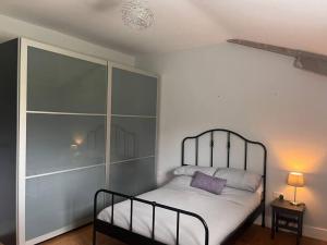 a bedroom with a bed with a metal headboard at 2 Bedroom Barn Conversion in Leicester
