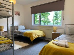 a bedroom with two bunk beds and a window at The Bunkhouse in Applecross