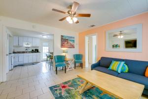 a living room with a blue couch and a table at Beautiful Rockport Home - Walk to Aransas Bay! in Rockport