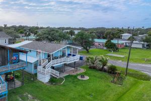 an aerial view of a blue house with a yard at Beautiful Rockport Home - Walk to Aransas Bay! in Rockport