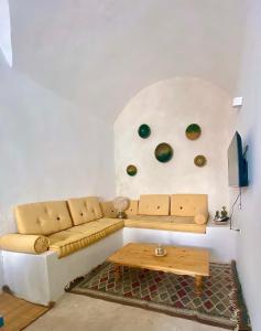a living room with a couch and a table at Dar Lily in Erriadh