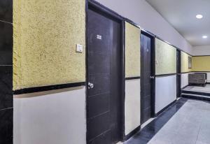 a row of doors in a hallway of a building at Super Hotel O Qualia Hotel Dilsukhnagar Near Dilsukhnagar Metro Station in Hyderabad