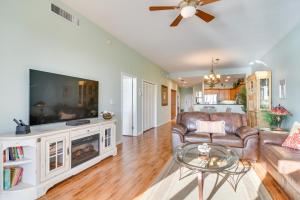 a living room with a couch and a tv at Coastal Condo with Harbor Views Steps to Beach! in Clearwater Beach