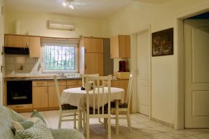 a kitchen with a table and chairs in a room at Vasiliki's Apartment in Psakoudia