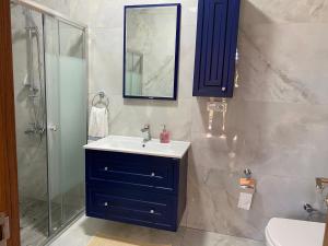 a bathroom with a blue cabinet and a sink at Doğa villa in Yomra