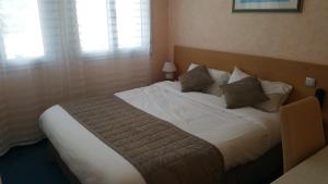 Postel nebo postele na pokoji v ubytování Hotel De La Mer