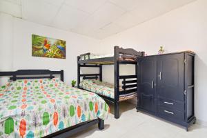 a bedroom with two bunk beds and a dresser at Casa Hotel Nurandy in Cartagena de Indias