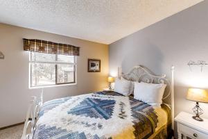 a bedroom with a bed and a window at The Pine Cone - Permit #3255 in Estes Park