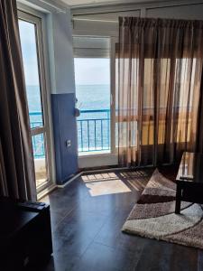 a living room with a view of the ocean at Apartmani Orange Dreams in Sutomore