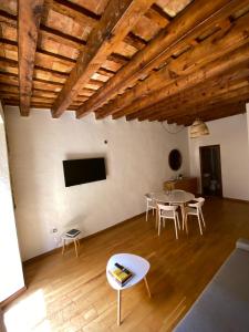 een kamer met een tafel en stoelen en een televisie bij Apartamento casco antiguo tarragona in Tarragona