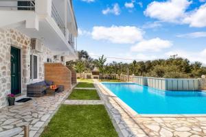 a swimming pool in the backyard of a villa at Sea view apartments in Tsoukaladhes