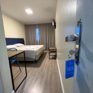 a hospital room with a bed and a sign on the wall at Hotel Suntuoso in Brasilia